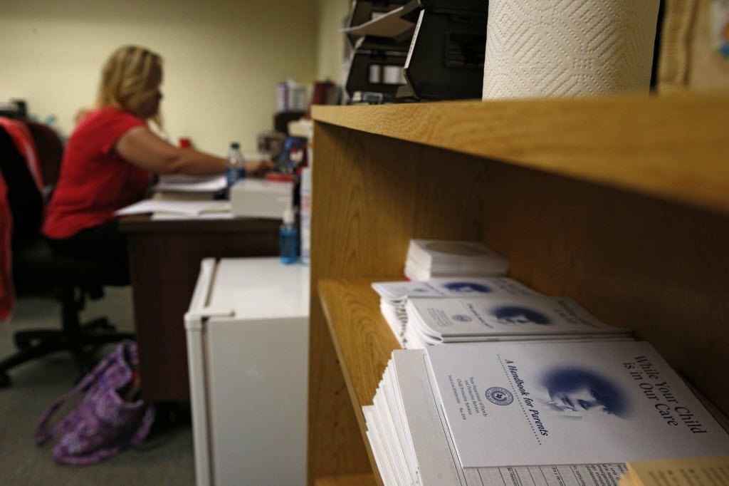 A Child Protective Services child-abuse investigator caught up on paperwork at her Fort...
