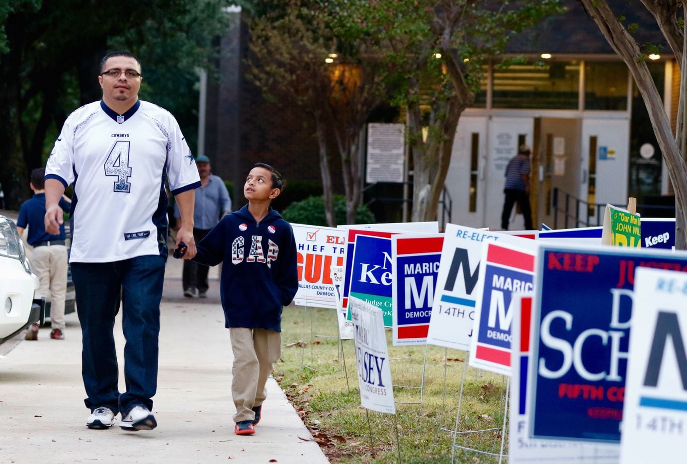 Sergio Cruz, left, with his son Nathan, 8, walk back to their car after Nathan watched his father vote early at the Dallas County Government Center, Precinct 5, on Beckley Ave and Twelfth St in Oak Cliff on Friday, November 4, 2016.