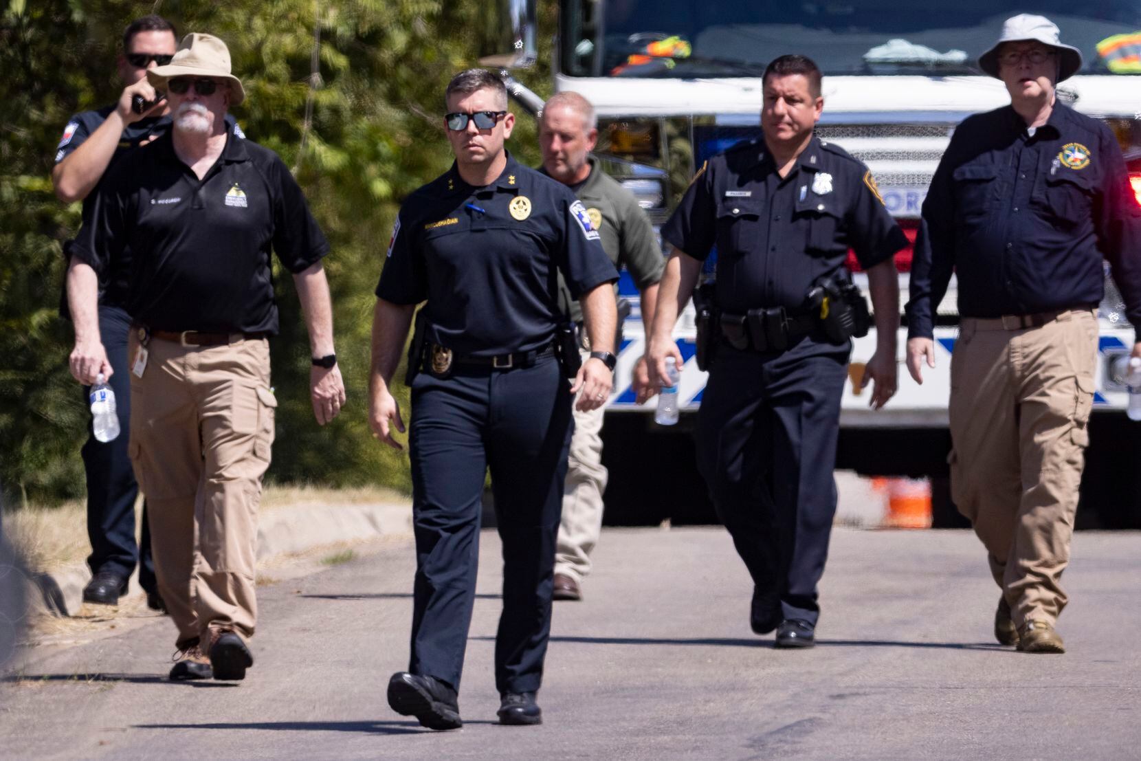 Lake Worth Police Chief JT Manoushagian (center) walks the scene close to where a military training aircraft crashed in a residential area on Sunday, Sept. 19, 2021, in Lake Worth. Two pilots were injured and three homes were damaged, officials said.  
