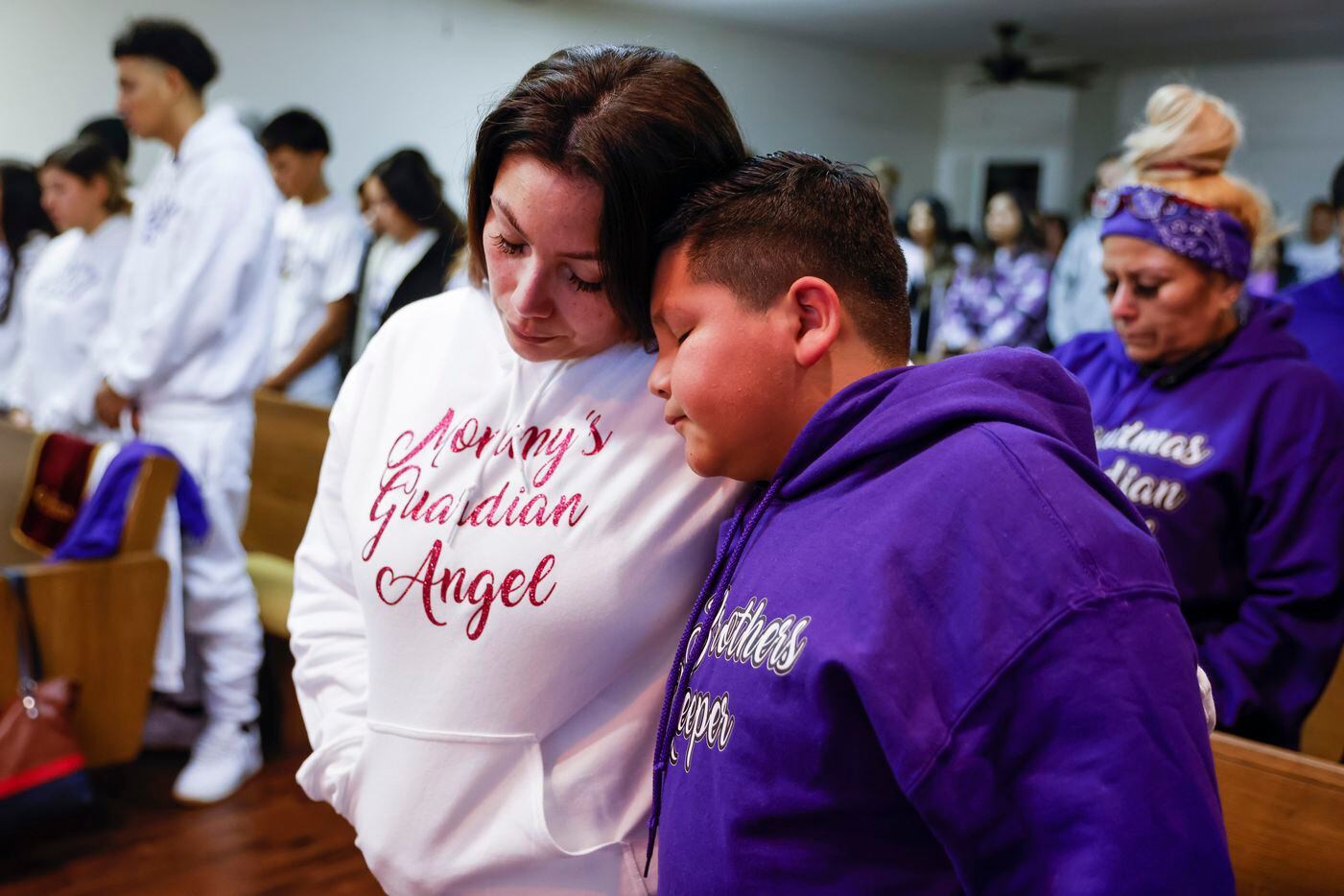 Mirtha Robles, mother of late Gabriel Zamora, 14, shares a moment with her other son Ayden...