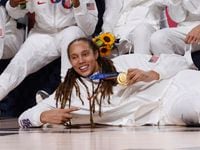 USA’s Brittney Griner (15) and team pose for photos during the medal ceremony for the...