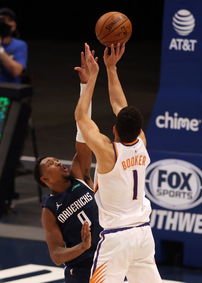 Phoenix Suns guard Devin Booker (1) shoots and makes the go ahead three pointer to win the game over Dallas Mavericks guard Josh Richardson (0) during the fourth quarter of play at American Airlines Center on Monday, February 1, 2021in Dallas. The Dallas Mavericks lost to the Phoenix Suns 109-108. (Vernon Bryant/The Dallas Morning News)