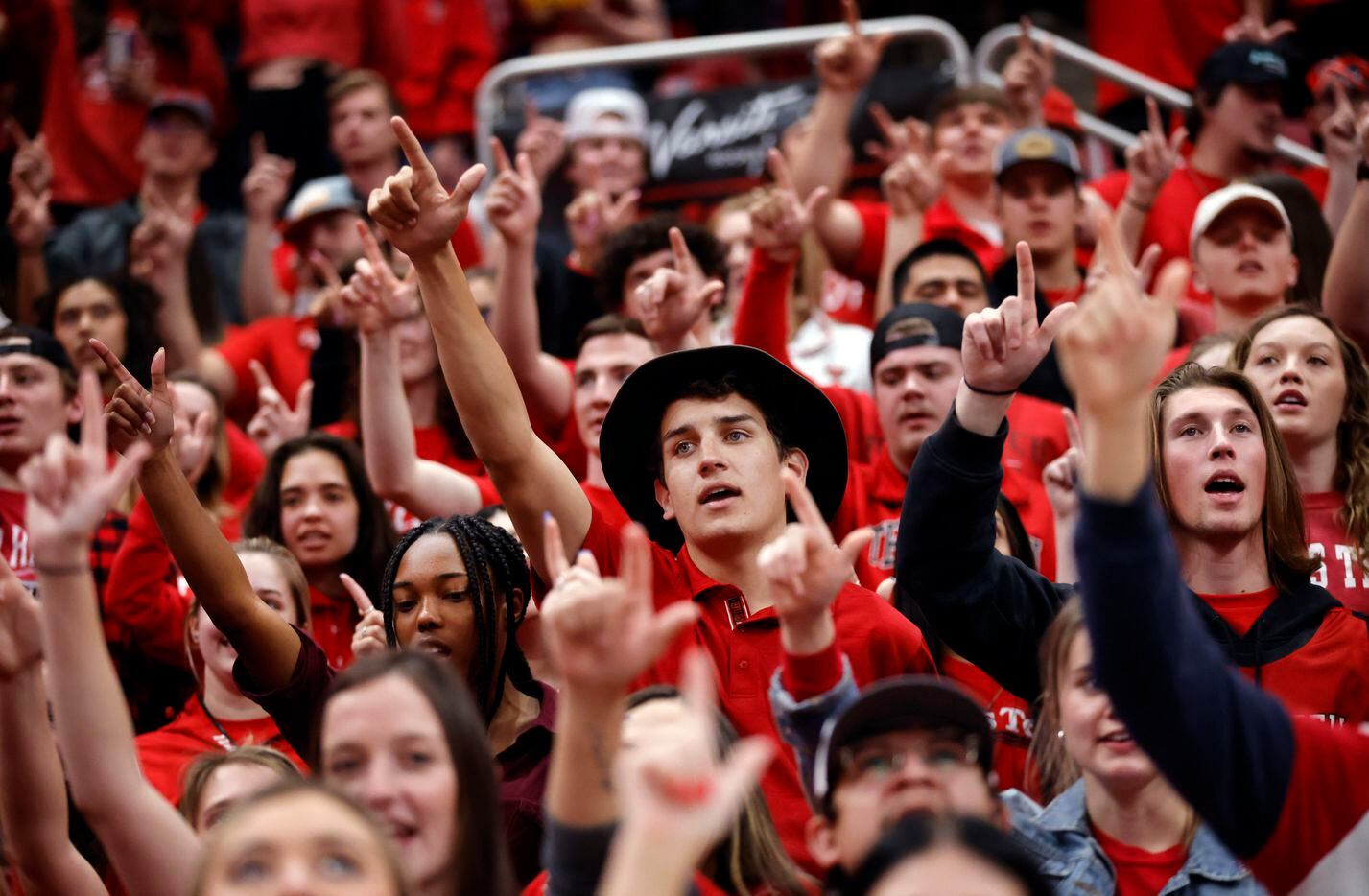 The Texas Tech Red Raiders student body get their ‘guns up’ hand sign before their team...