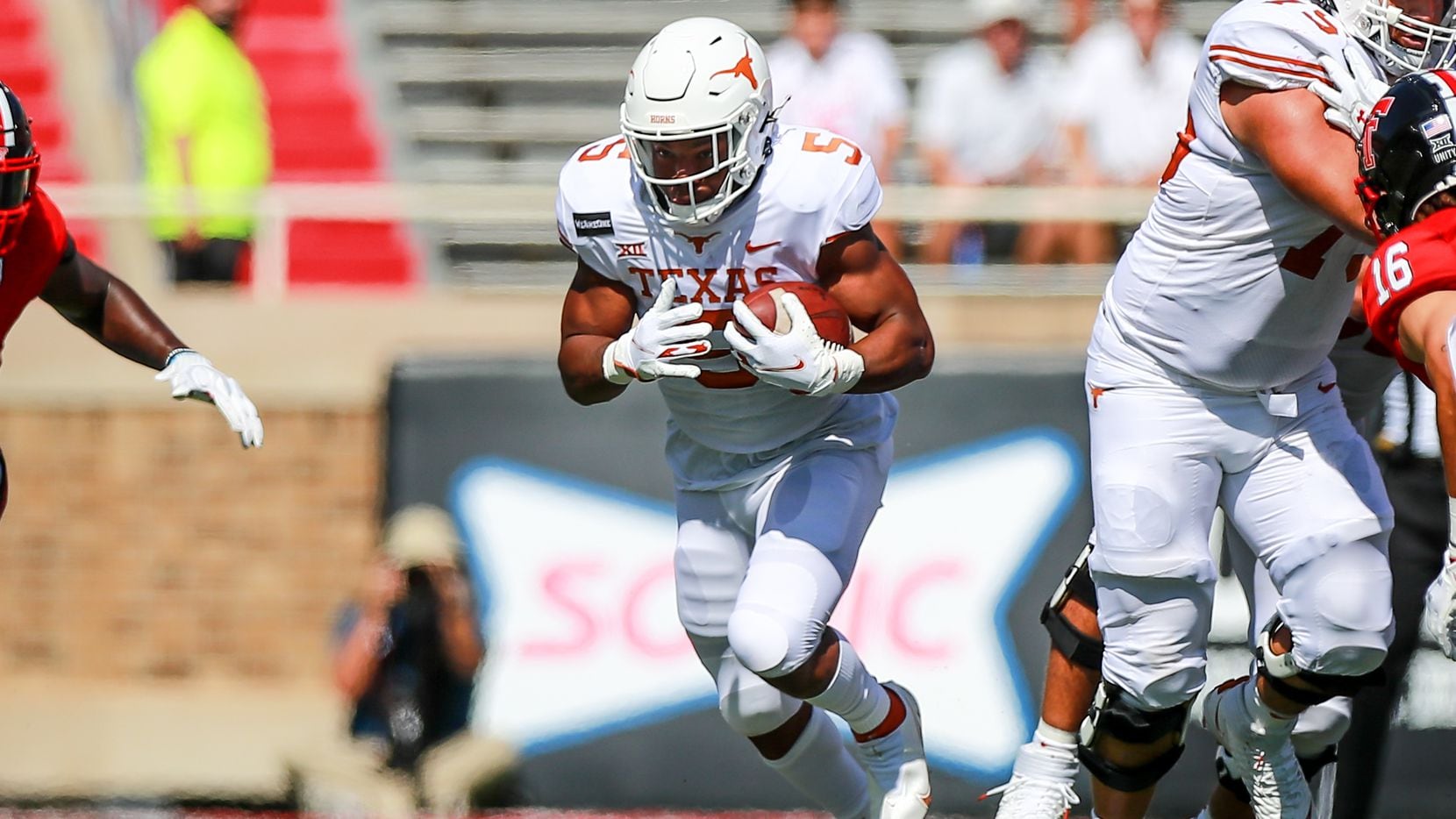Running back Bijan Robinson #5 of the Texas Longhorns runs the ball during the first half of...