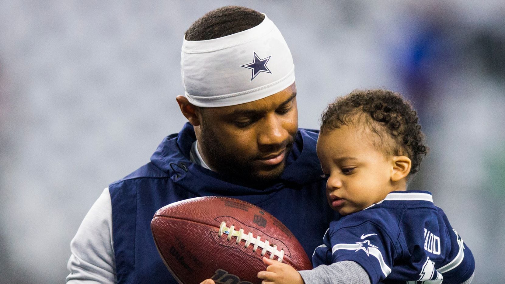 Dallas Cowboys wide receiver Randall Cobb (18) hands a football to his son, Caspian Cyrus Cobb, during warmups before an NFL game between the Dallas Cowboys and the Washington Redskins on Sunday, December 29, 2019 at AT&T Stadium in Arlington, Texas.