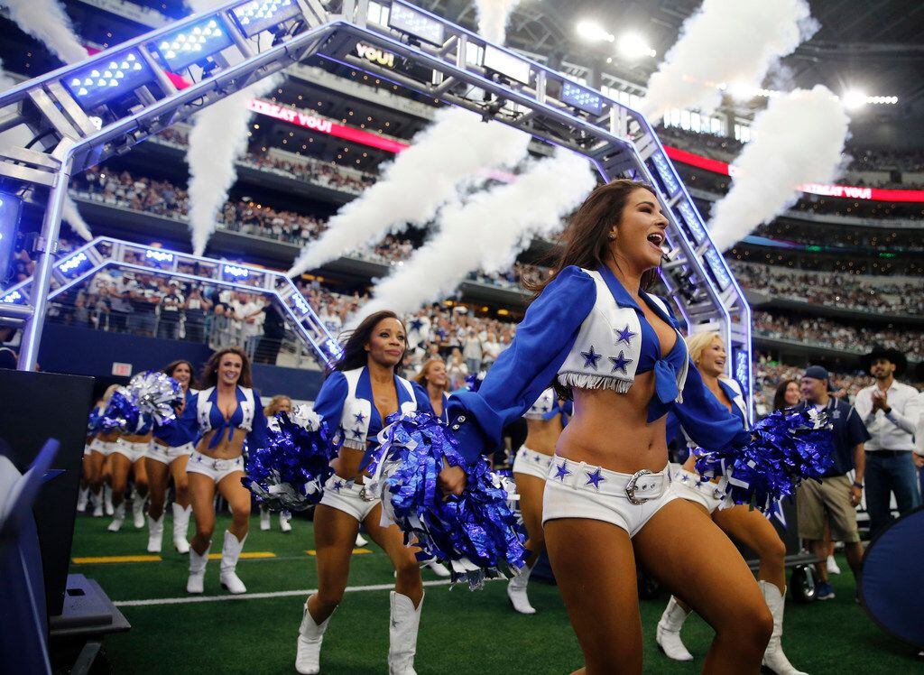 Dallas Cowboys cheerleaders take the field before introductions at the home opener between...