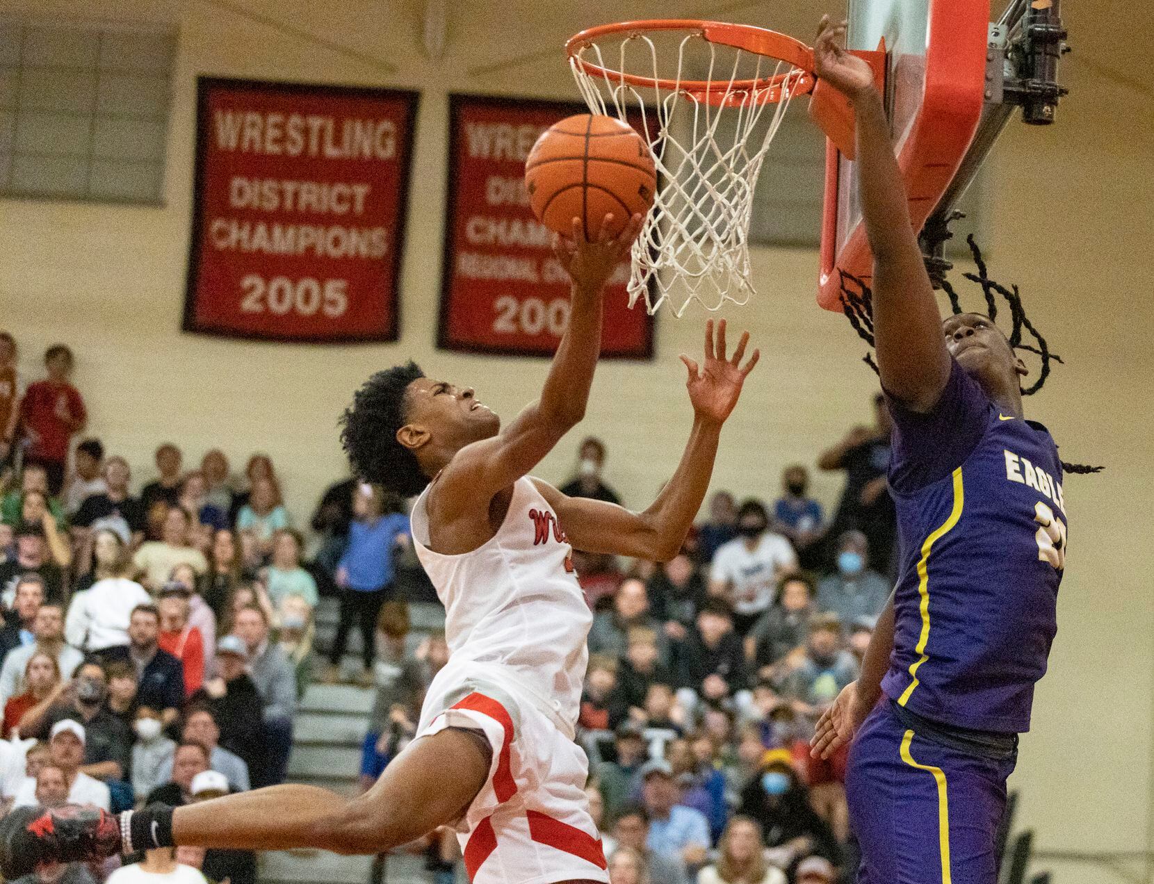 Lake Highlands BJ Davis (3) jumps to score a basket while Richardson High School Cason...
