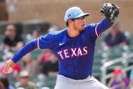 Texas Rangers pitcher Dane Dunning delivers during the first inning of a spring training...