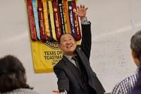 Yujun Liang delivers a speech during a Texas Dragon Toastmasters Club meeting at the...