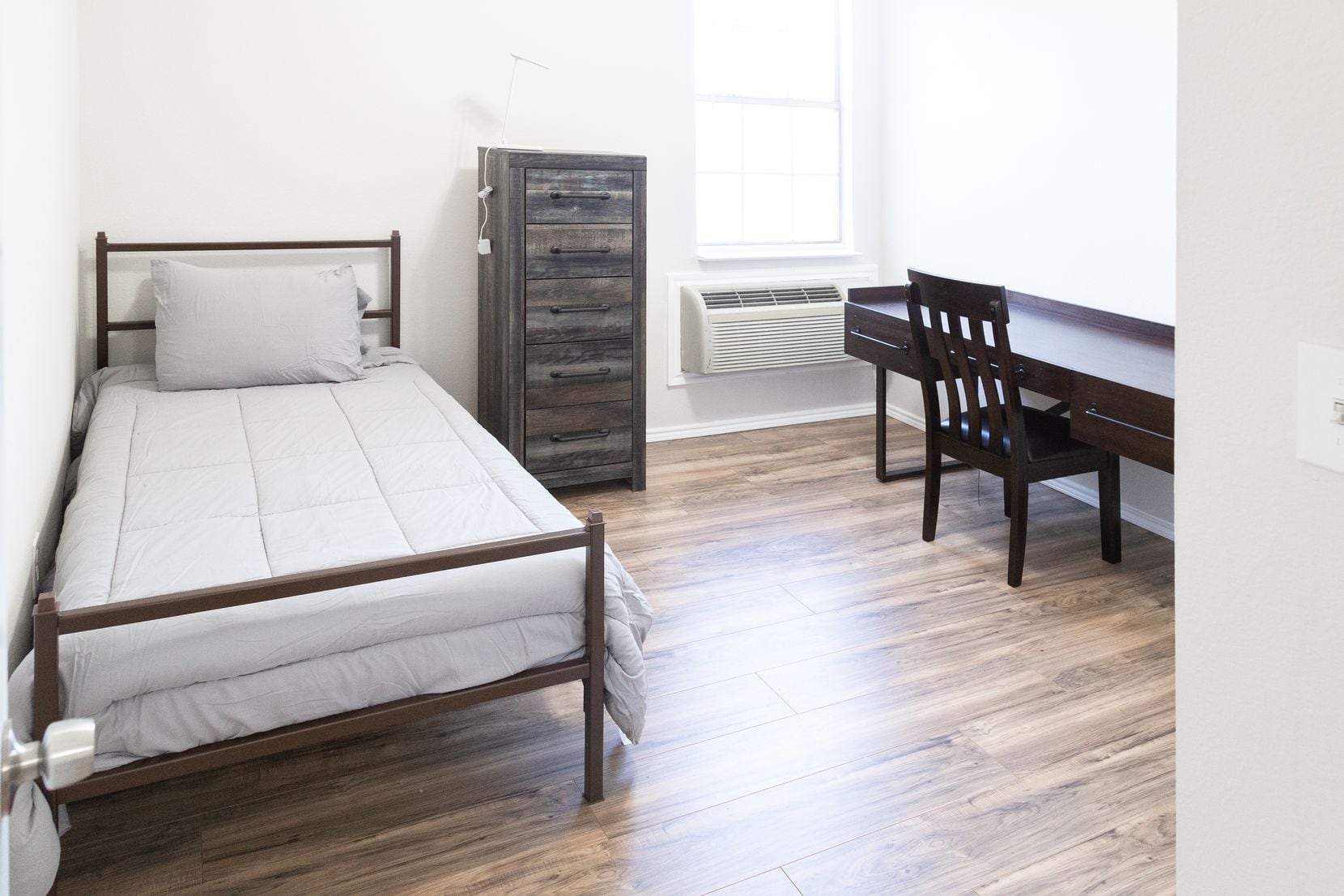 A bedroom furnished with a bed, desk, chair, and dresser at Tillman House, a sober living...