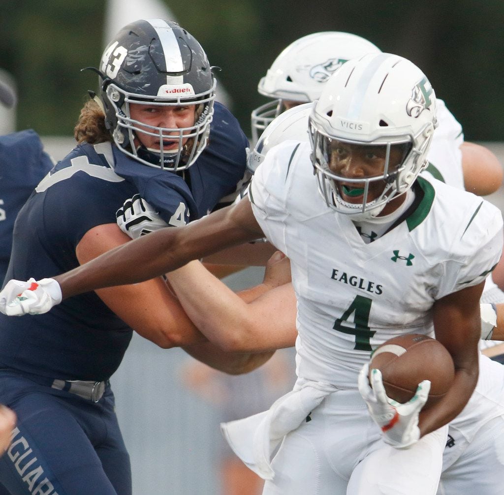 Prosper receiver Tyler Bailey (4) rushes into the Flower Mound secondary as he is pursued defensively by tackle Travis McFarling (43) during first half action. The two teams played their Class 6A football game at Flower Mound High School in Flower Mound on September 13, 2019. (Steve Hamm/ Special Contributor)