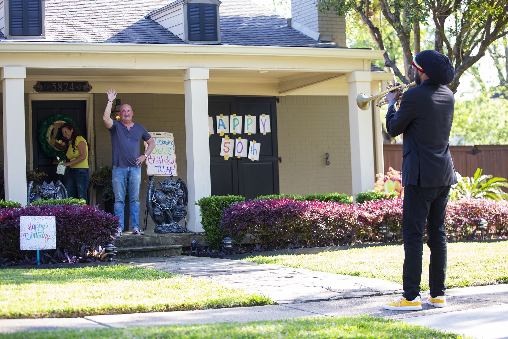 Trumpeter Alcedrick Todd (right) performs for David Hannah's 50th birthday outside of his house after his wife Dina Hannah posted on the Nextdoor app looking for a trumpet player on April 10, 2020 in Dallas. The couple originally planned to celebrate the birthday in New Orleans. (Juan Figueroa/ The Dallas Morning News)