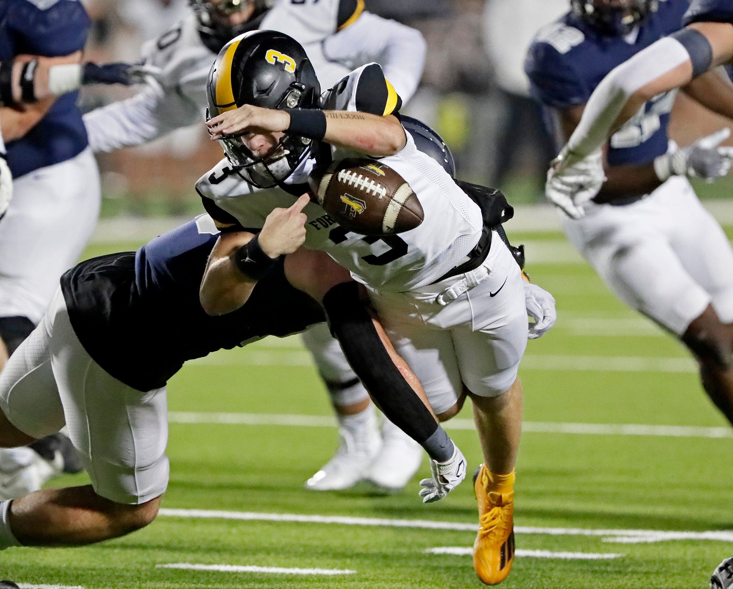 Forney High School quarterback Kyle Crawford (3) fumbles as he is hit by Lone Star High...