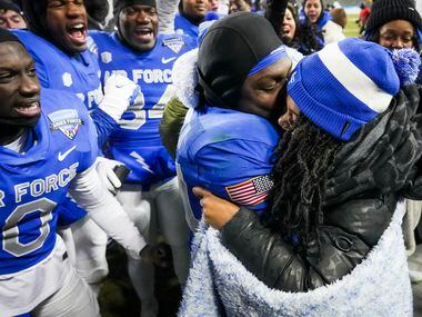 Air Force defensive back Cameron Breier (24) hugs Shanice Atkins after she accepted his...