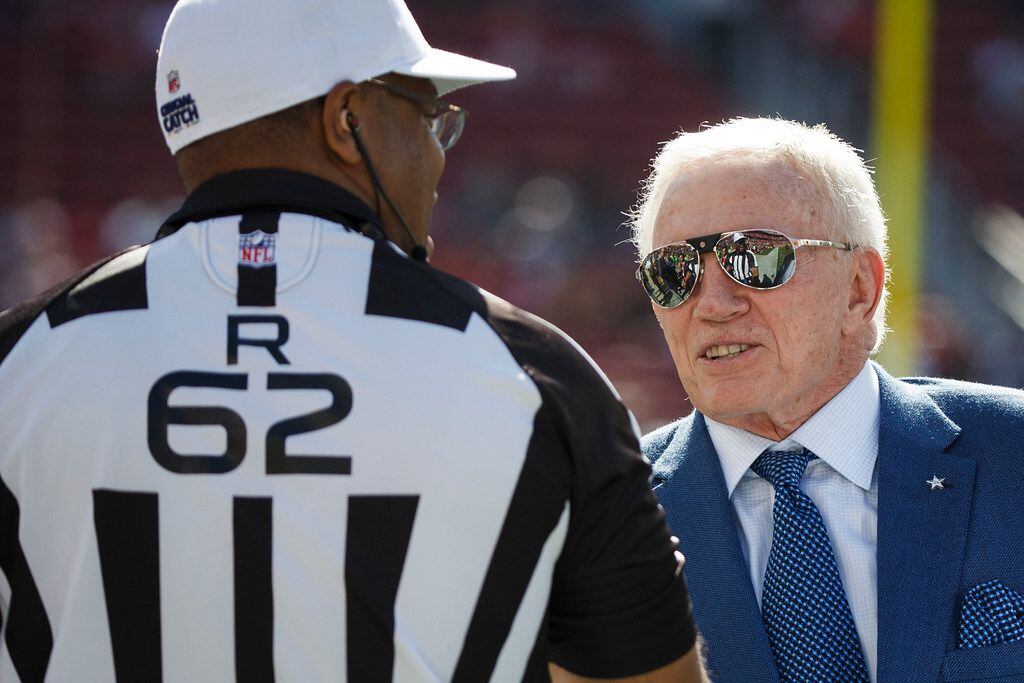 Dallas Cowboys owner Jerry Jones shakes hands with referee Ron Torbert before an NFL...