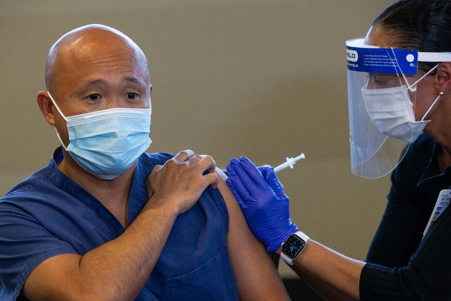 Parkland's chief medical officer, Dr. Joseph Chang, shown receiving one of his COVID-19...