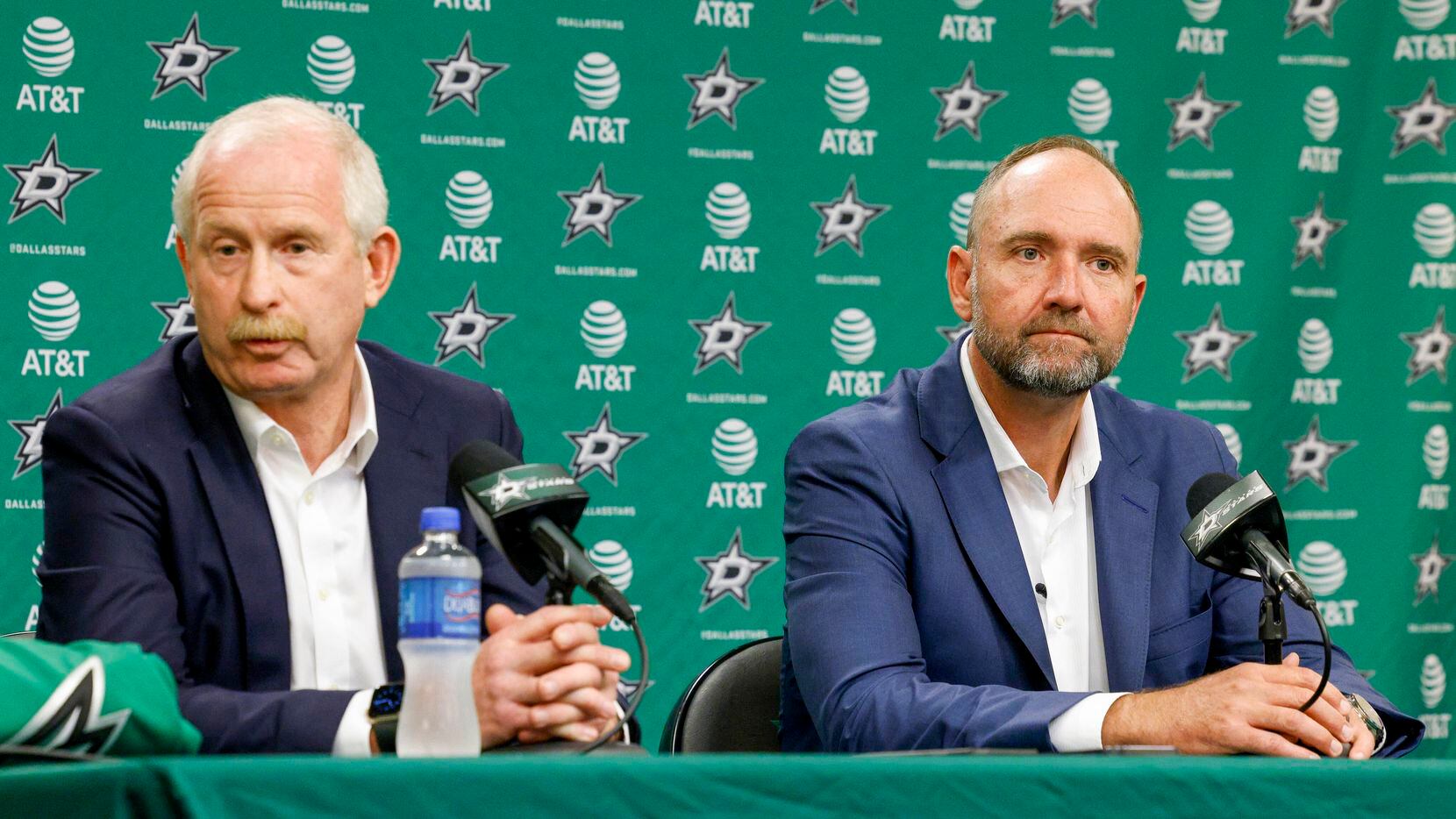 Jim Nill, Dallas Stars general manager (left), answers a question from a reporter alongside...