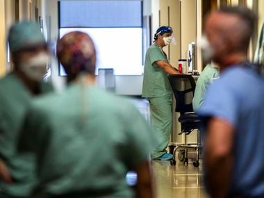 The first federal shipments of COVID-19 vaccine to Texas should arrive the week of Dec. 14, Gov. Greg Abbott announced Wednesday. In photo, medical staff work in the COVID-19 Intensive Care Unit at Parkland Memorial Hospital in Dallas last month.