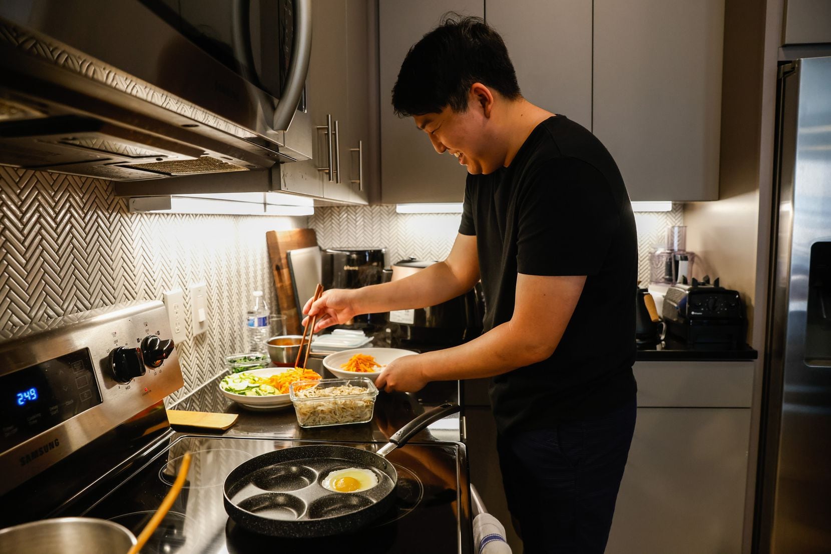 Kyong Han prepares Bibimbap with Ground Beef at his home in Plano.
