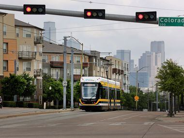 The Dallas streetcar approaches the intersection of Zang and Colorado as it ambles along its...