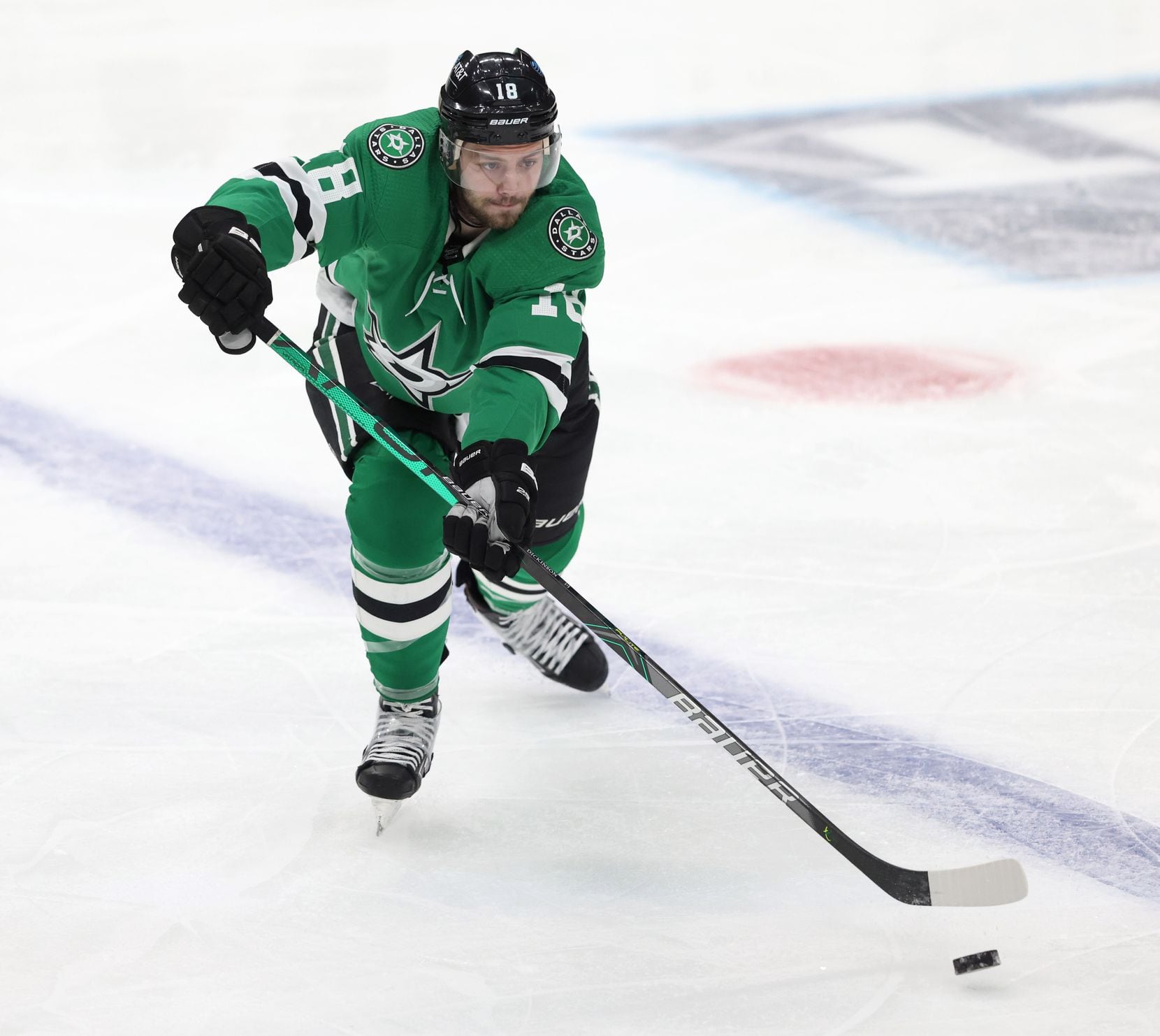 Dallas Stars center Jason Dickinson (18) passes the puck in a game against the Nashville...