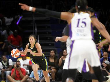 Dallas Wings guard Veronica Burton (12) brings the ball up court during the first half of...