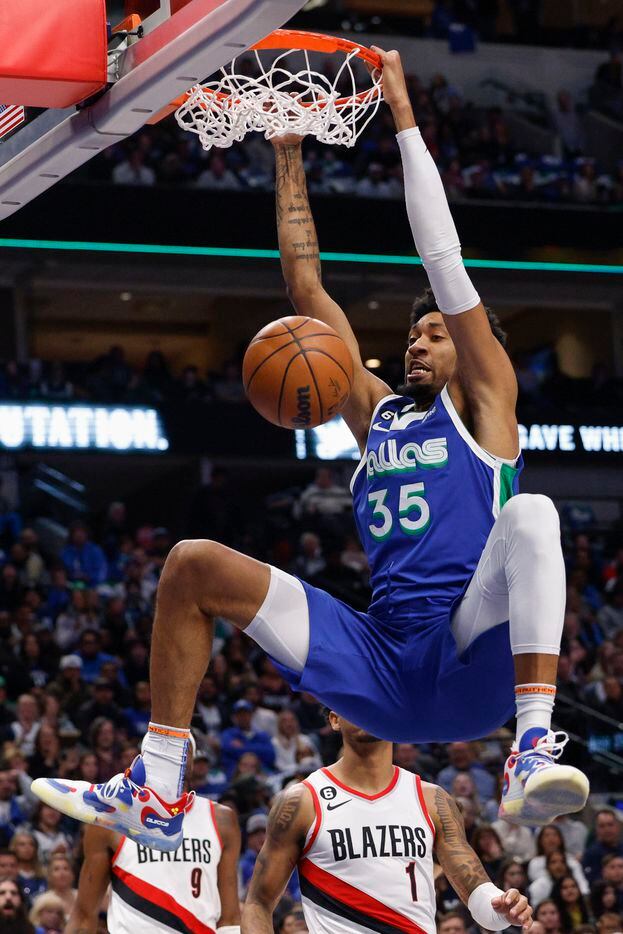 Dallas Mavericks center Christian Wood (35) dunks the ball during the first half of an NBA...