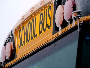 Icicles from sleet and rain coat a school bus Thursday, Feb. 2, 2023, in Richardson, Texas....