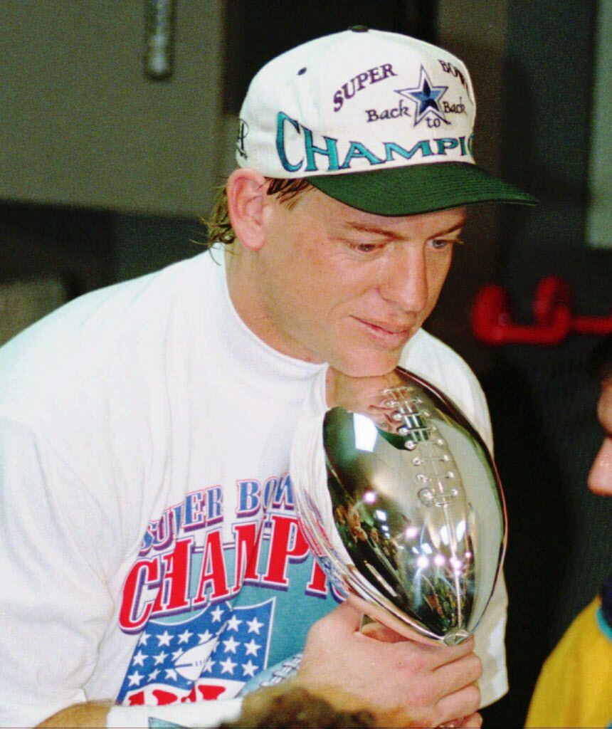 Dallas Cowboys quarterback Troy Aikman rests his chin on the Super Bowl trophy, Sunday, Jan....