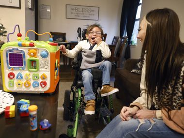 Cheyenne Oakley plays with her son 3 yr-old Sutton, who is confined to chair because of his cerebral palsy, at their Burleson, Texas home, November 27, 2021. Sutton was in a class of mostly nonverbal 3-year-olds with disabilities at Norwood Elementary. Some teachers are accused of muffling the students' cries with their own hands, scratching them underneath their armpits to not leave any visible marks and openly ridiculing their disabilities. Cheyenne is one of several parents who are asking the school district and PD to investigate the incident, and the school to place cameras in her classroom. (Tom Fox/The Dallas Morning News)