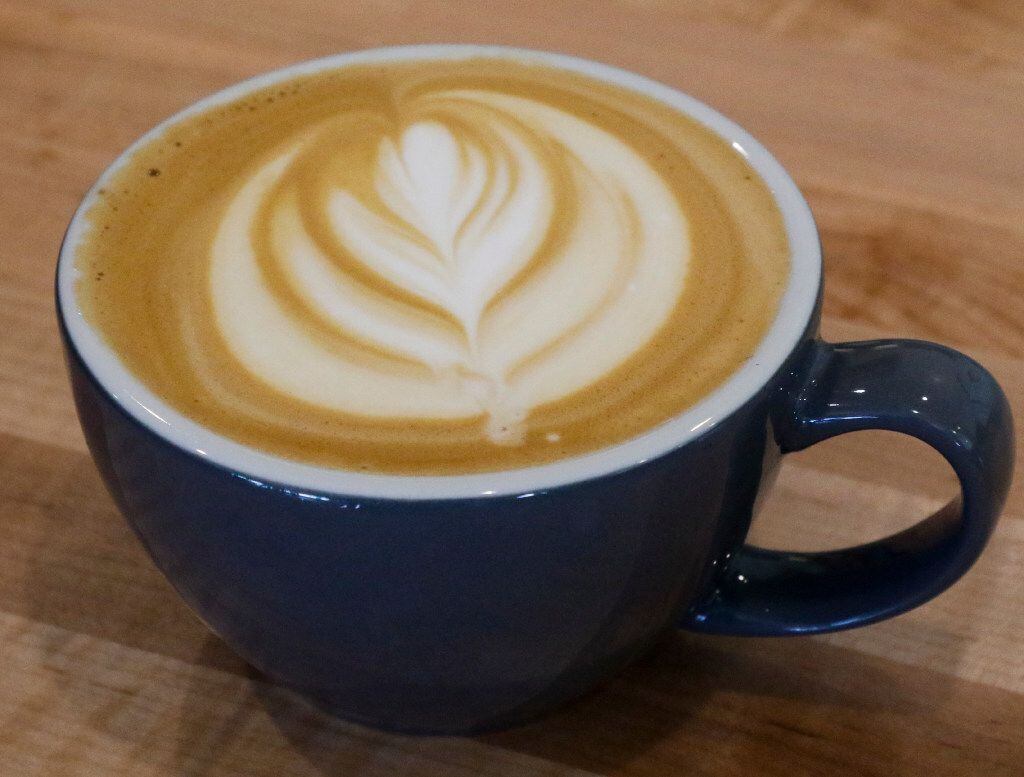 A finished plain latte photographed at the new GEORGE | Coffee + Provisions in Coppell,...