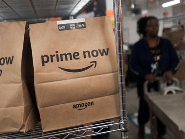 In this Dec. 20, 2017, photo, Prime Now customer orders are ready for delivery at the Amazon warehouse in New York. (AP Photo/Mark Lennihan)