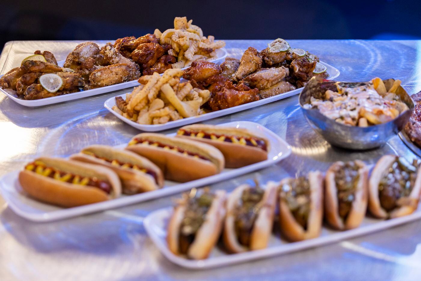 A sampling of food, including hot dogs and seasoned chicken wings, available for purchase at...