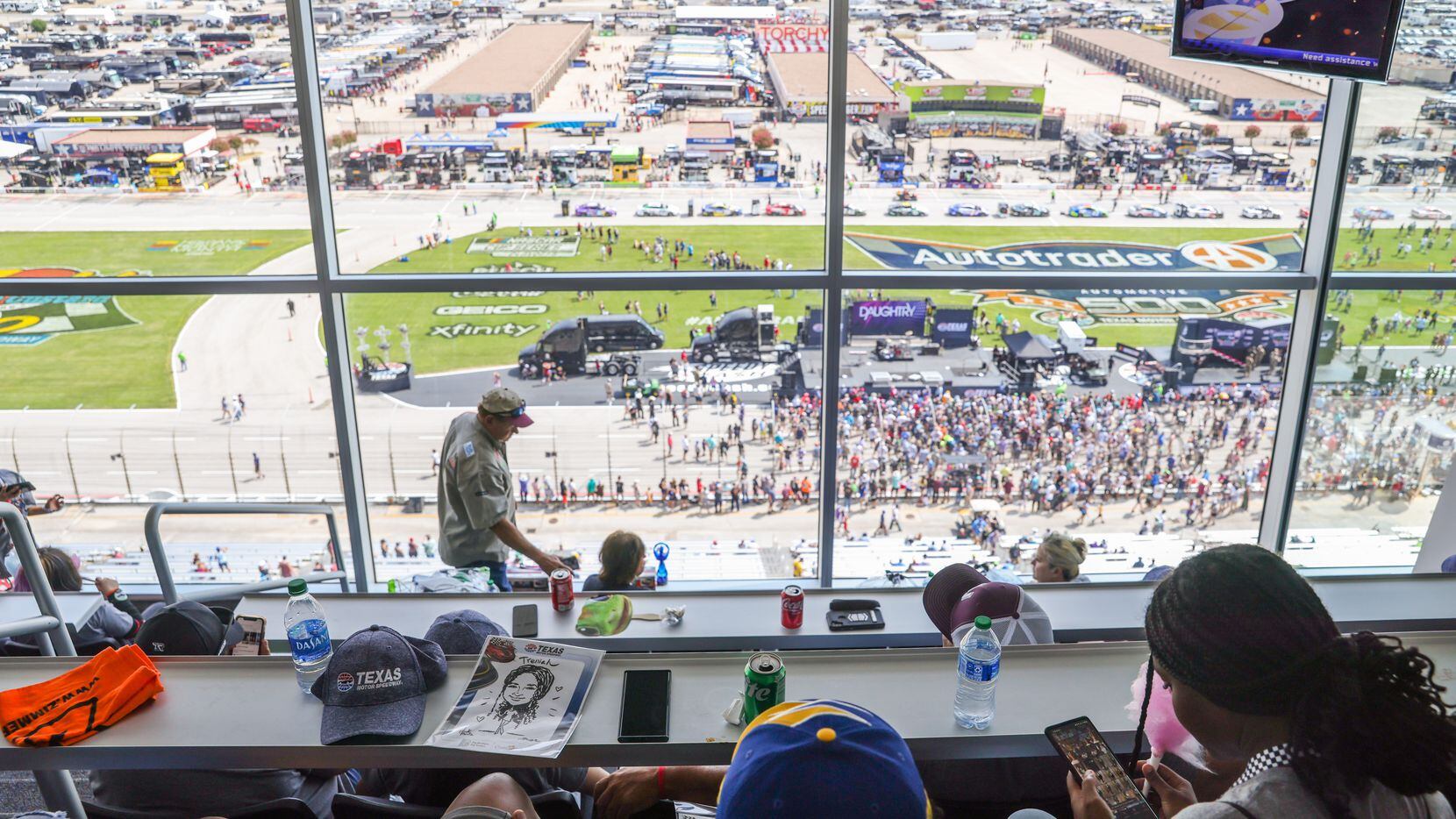Uvalde families and volunteers look out over the Fall NASCAR Playoffs with a box view hosted...