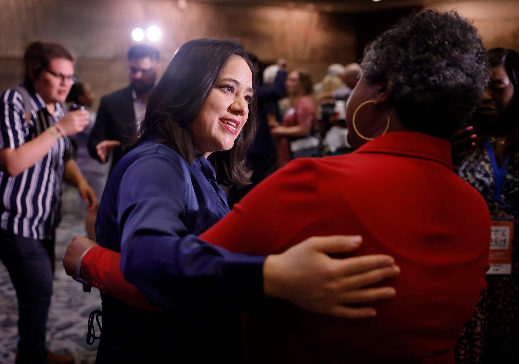 Texas attorney general candidate Rochelle Garza (left) is greeted by state Rep. Rhetta...