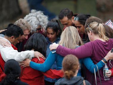 Parents gathered in a circle to pray at a recreation center where students were reunited...