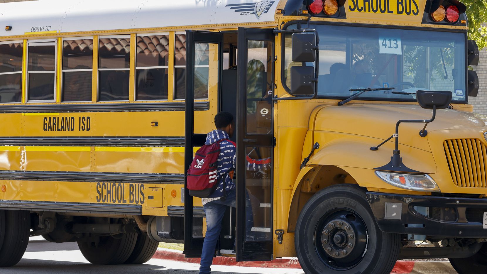 Students board a Garland ISD bus outside Garland High School on Friday. The district will...