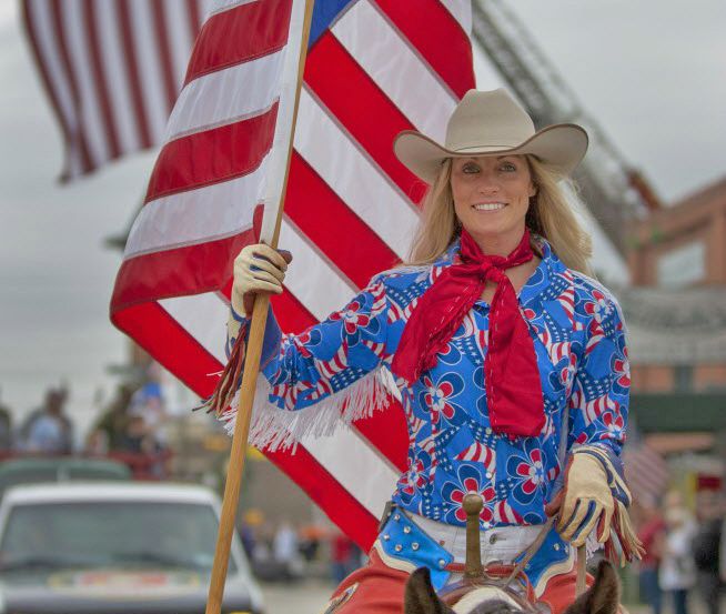 Professional trick-rider Erin Butler rides her horse in the Grapevine Veterans Day parade.