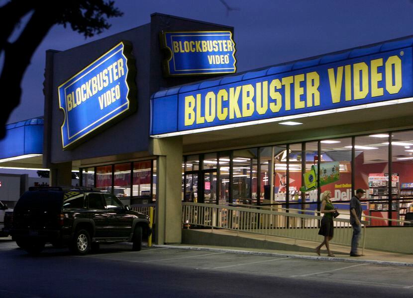 Customers enter a Blockbuster video store in Dallas on the evening of July 23, 2006.
