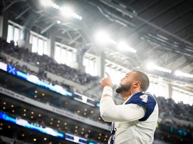 Dallas Cowboys quarterback Dak Prescott stands points skyward before an NFL football game against the Arizona Cardinals at AT&T Stadium on Sunday, Jan. 2, 2022, in Arlington.