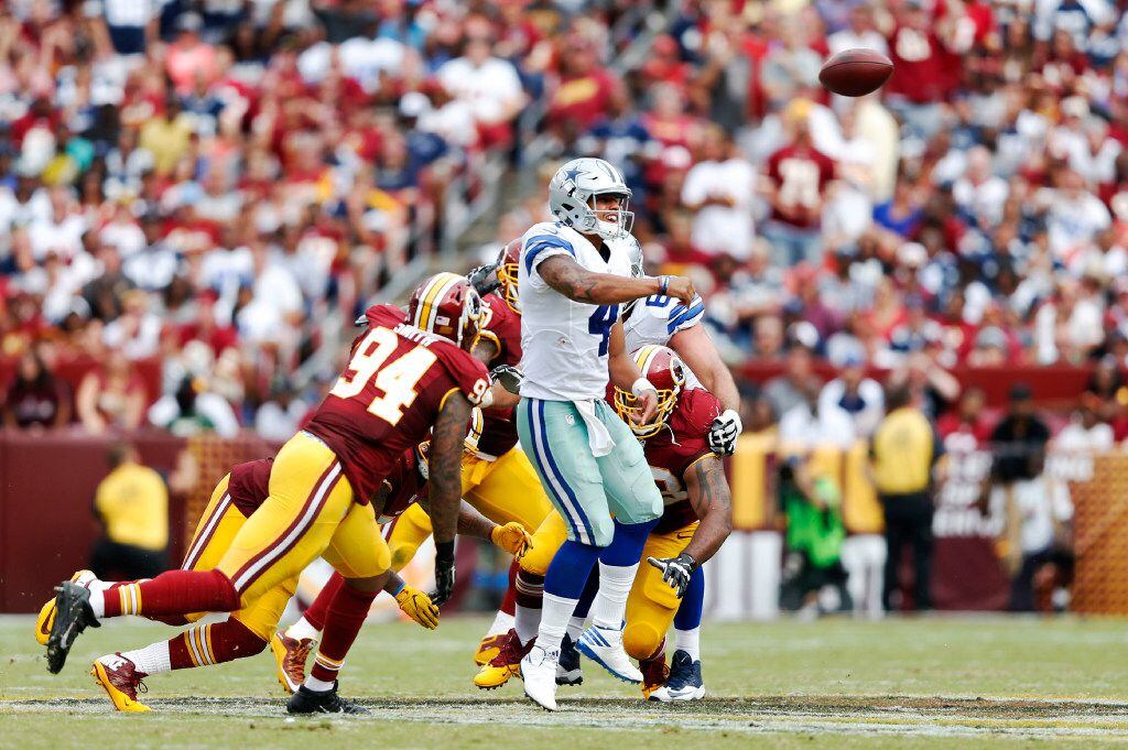 Dallas Cowboys quarterback Dak Prescott (4) evades Washington Redskins outside linebacker...