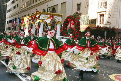 Christmas tree dancers perform during the holiday parade through downtown Dallas