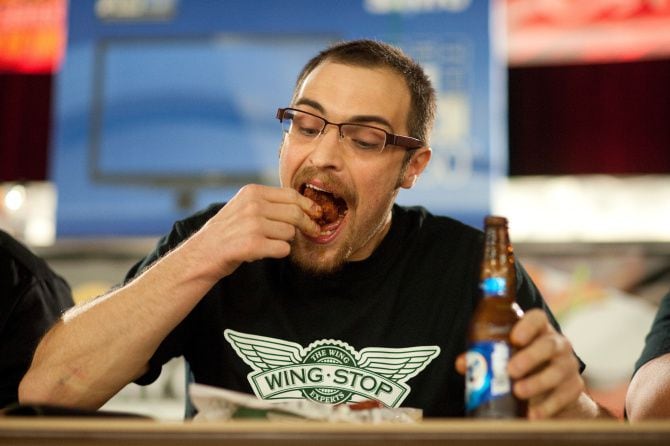 Tyson Henry downs "atomic" hot wings during the final round of competition at ZestFest in...