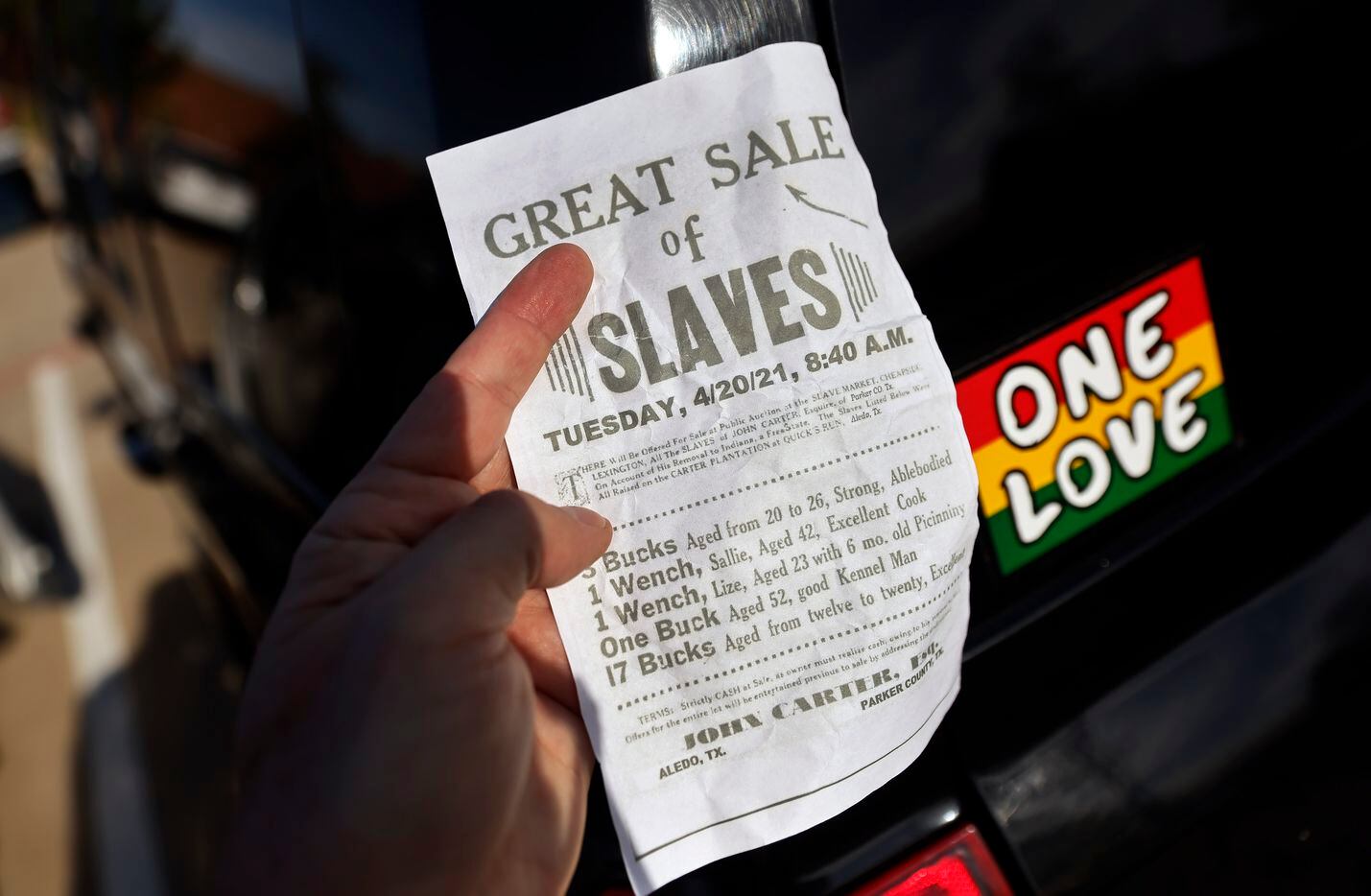 One of the flyers that were​ blowing near the Aledo ISD Monday is pictured outside an Aledo ISD school board meeting, Monday, April 19, 2021. Parents and supporters came to the meeting to voice their concerns about a racist Snapchat group with multiple names, including “Slave Trade” and another that included a racial slur. (Tom Fox/The Dallas Morning News)