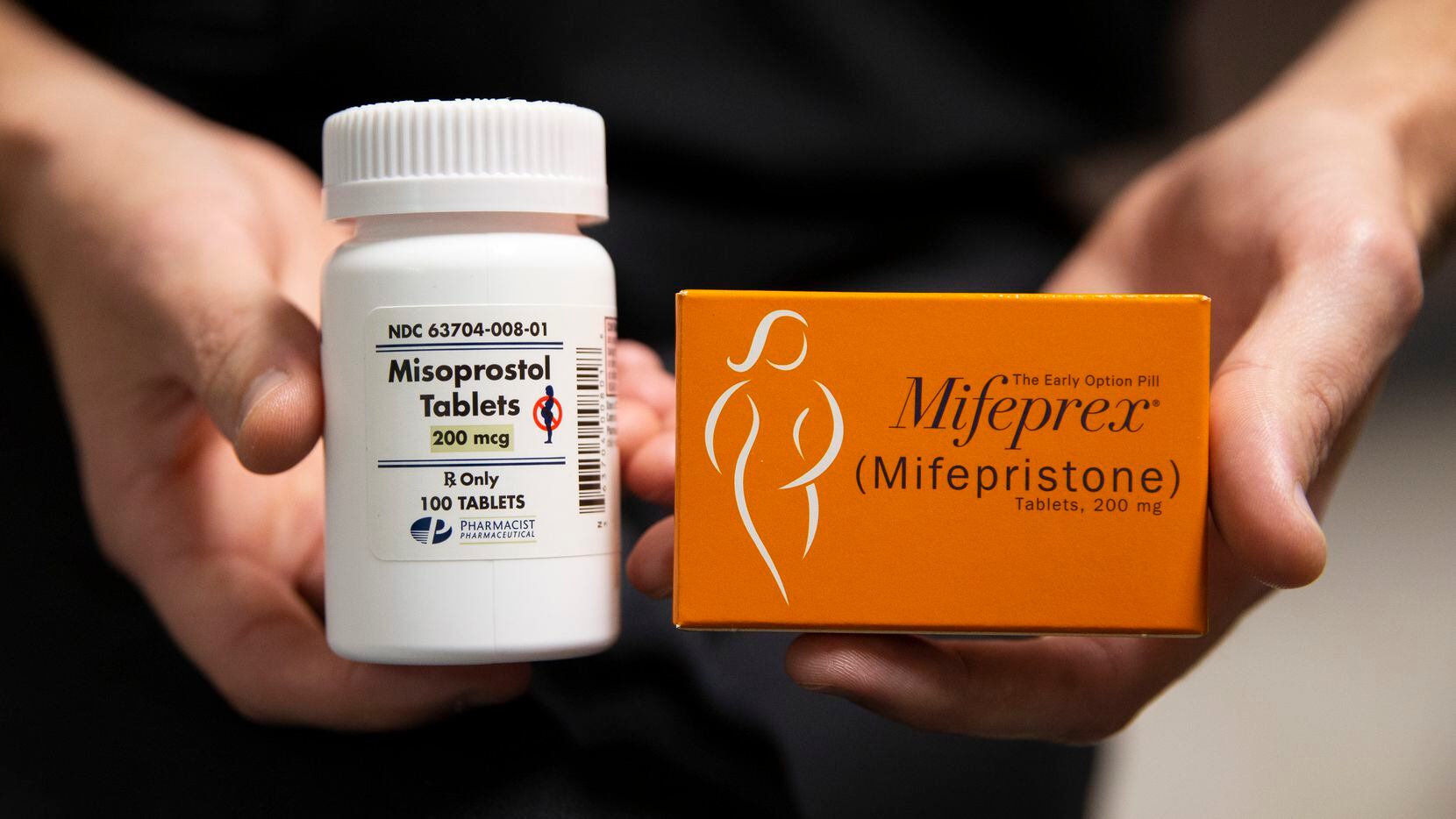 Dr. Joe Nelson holds a bottle of Misoprostol and a box of Mifeprex (Mifespristone)...