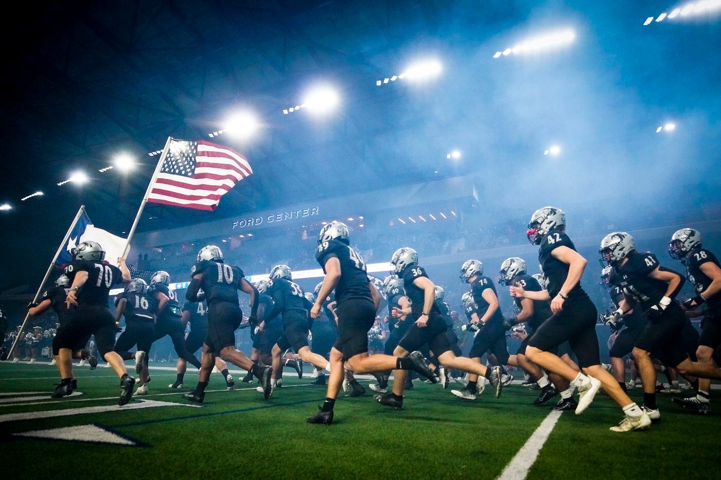 Denton Guyer players take the field a Class 6A Division II area-round high school football...