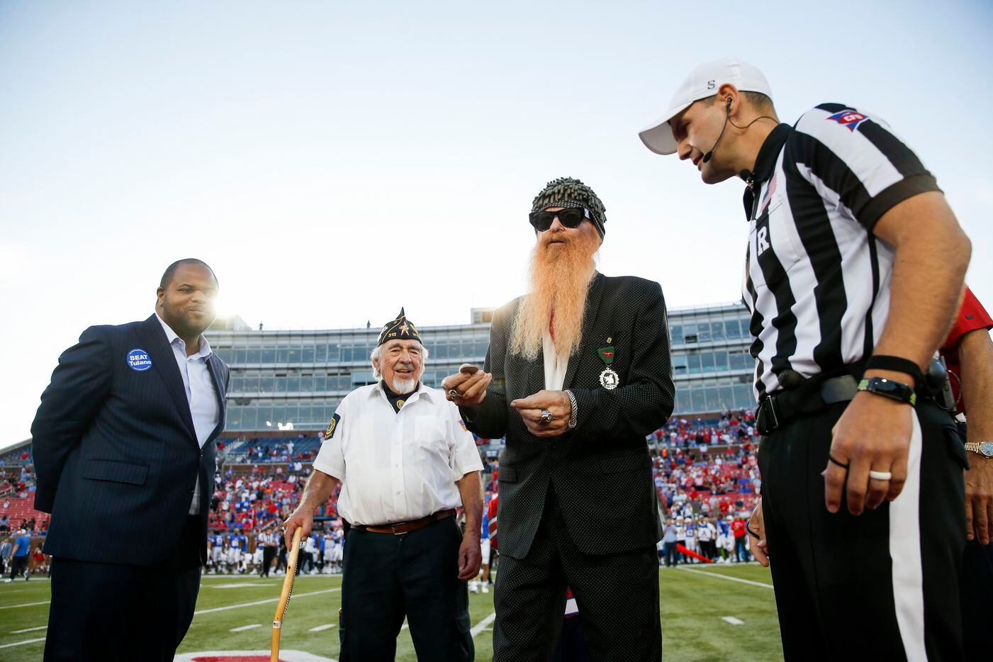 Dallas Mayor Eric Johnson (left) and ZZ Top's Billy Gibbons (second to left) prepare for the...