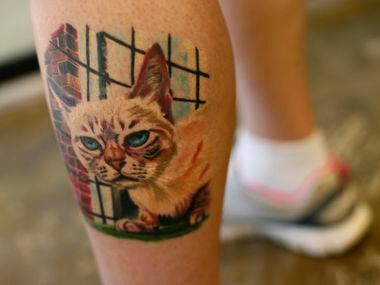 Amy Bender from Oklahoma City, shows her tattoo of her cat, Sauerkraut the famous rescued...