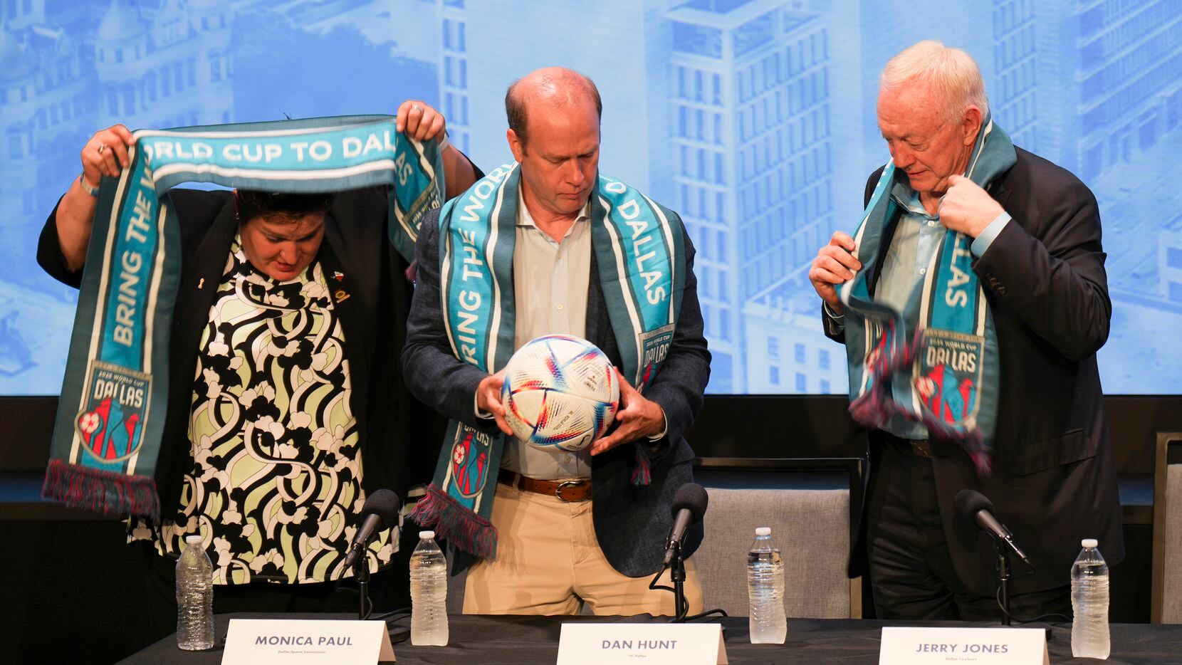 Monica Paul (from left), Dan Hunt and Jerry Jones don Dallas World Cup scarves during a...