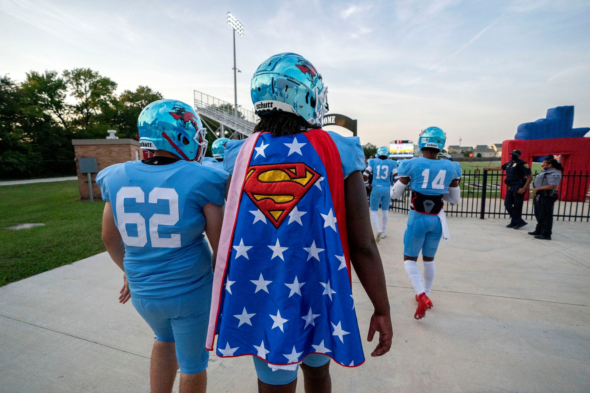 Skyline senior quarterback Darryl Richardson (2) wears a Superman cape as he takes the field...